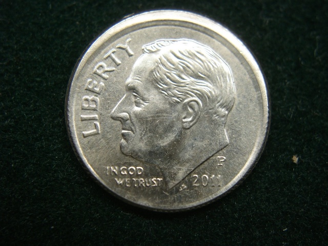 2011 Roosevelt dime off-center strike error showing design shifted off-center with blank planchet visible